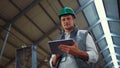 Farmer working tablet computer in shed. Agricultural engineer posing alone. Royalty Free Stock Photo