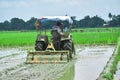 Farmer working during the tractor plowing fields -preparing land for Rice field