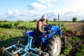 The farmer works in the field with a tractor. Agroindustry and agribusiness. Farm field work cultivation. Farming machinery. Royalty Free Stock Photo