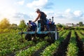 The farmer works in the field with a tractor. Agroindustry and agribusiness. Farming machinery. Plowing and loosening ground. Crop