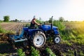 The farmer works in the field with a tractor. Agroindustry and agribusiness. Field work cultivation. Farm machinery. Crop care Royalty Free Stock Photo