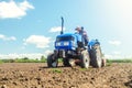 The farmer works on a tractor. Loosening the surface, cultivating the land for further planting. Cultivation technology equipment