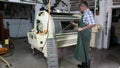 Farmer works on a wine press machine to pressing out white wine gapes.