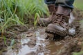 farmers boots trudging through a muddy field Royalty Free Stock Photo