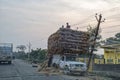 Farmers carry goods on their pickup van at a village