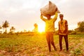 Farmers carry harvested vegetables at sunrise in Mwanza, Tanzania