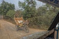 Farmers carry wooden stff on their bicycles at a village