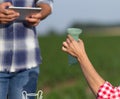 Farmers checking rain fall on gauge in field Royalty Free Stock Photo