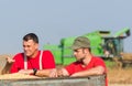 Farmers examine soyabean in trailer after harvest Royalty Free Stock Photo