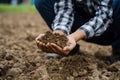 Farmers' expert hands check soil health before planting vegetable seeds or seedlings. Business idea or ecology