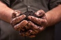 Farmers hand holding soil surface