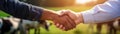 Farmers Handshake Against Backdrop Of Unfocused Agriculture With Cows, Closeup Panoramic Banner
