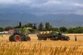 Farmers harvesting crops in the field using agricultural machinery in the Almaty region of Kazakhstan