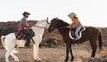 Farmers having fun riding a horses in corral ranch Royalty Free Stock Photo