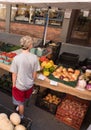 Farmers Market on a bright sunny day showing adults, children, dogs and vendors.