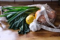 Farmers Market Produce in White Net Grocery Bag on Kitchen Countertop Royalty Free Stock Photo