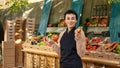 Farmers market vendor showing organic produce to clients