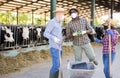 Farmers in protective masks discussing working process near stall