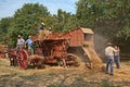 Wheat threshing with ancient equipment during the country fair Royalty Free Stock Photo