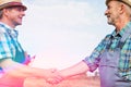 Farmers shaking hands in farm