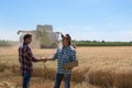 Farmers shaking hands in field during harvest Royalty Free Stock Photo