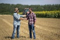 Farmers shaking hands in field during harvest Royalty Free Stock Photo