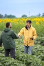 Farmers shaking hands in field Royalty Free Stock Photo