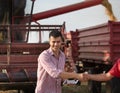 Farmers shaking hands during harvest Royalty Free Stock Photo