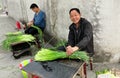 Pengzhou, China: Farmers Bundling Garlic Greens