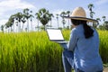 Farmers in Thailand concept. Thai beautiful farmer, and Hand in hand with a notebook computer