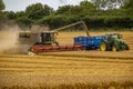 Farmers harvesting a wheat field in the county of Hampshire in the UK Royalty Free Stock Photo