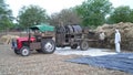 Farmers using a threshing machine to harvest Wheat or Rye in a field. Photo taken near Akhepura, Sikar, India 08 April 2021