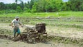 farmers work plowing rice fields using hand tractors Royalty Free Stock Photo