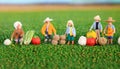 Farmers working on field in rural landscape, miniature figure, agriculture concept,ai generated