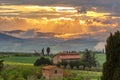 Farmhouse with garden in a scenic sunset landscape Royalty Free Stock Photo