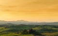 Farmhouse, green hills,cypress trees in Tuscany at sunrise