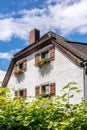 Part of an old farmhouse with flower boxes on the windows