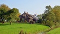 Farmhouse farm with waving flag in Jukwerd, Groningen