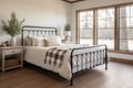 Farmhousestyle Guest Room With Wrought Iron Bed And Rustic Decor Modern Farmhouse Interior Design