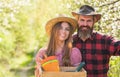 Farming couple. Happy couple hold gardeners tools. Family couple smile in spring garden. Couple in love in rural style