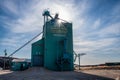 Grain elevator in prairies with sun peeking through