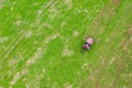 Farming machine from above on a green meadow