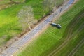 Farming machine spraying cow dung on a field from above