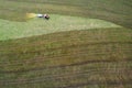 Farming machine spraying cow dung on a field from above