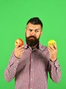 Guy presents homegrown harvest. Farmer with indecisive face