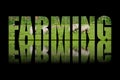 Farming text composed of green farm with sheep on black background with text reflection in water Royalty Free Stock Photo