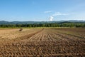 Farming with tractor and plow in field with mountain Papuk in Croatia Royalty Free Stock Photo