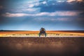 Farming tractor plowing and spraying on field Royalty Free Stock Photo