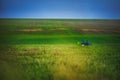 Farming tractor plowing and spraying on green wheat field Royalty Free Stock Photo