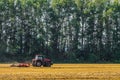 Farming tractor is working in the field Royalty Free Stock Photo